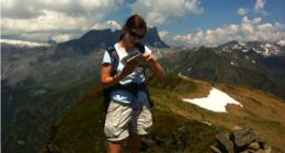 Checking the map on a self-guided trekking trip in the Alps